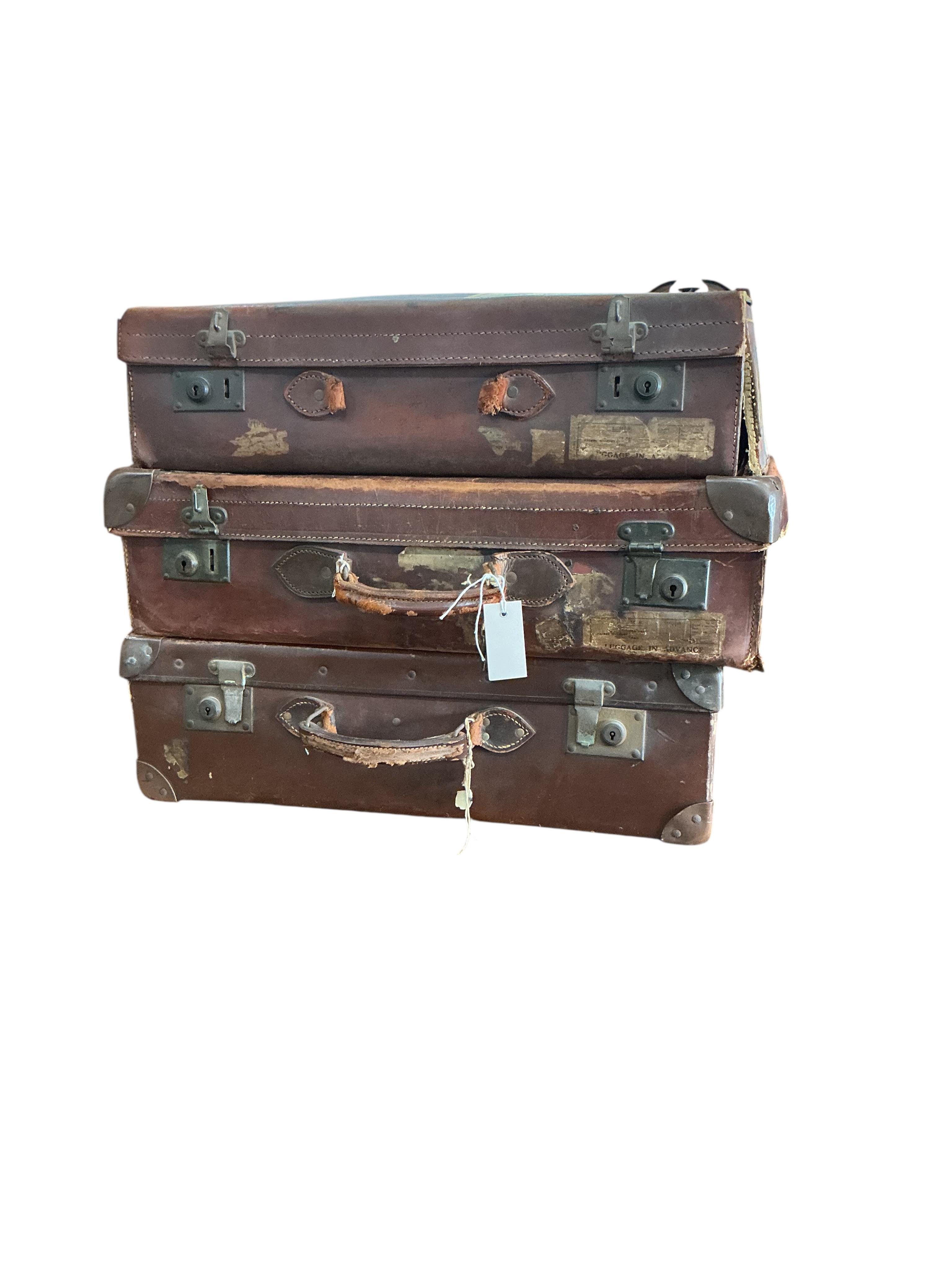 Three vintage suitcases, largest width 66cm